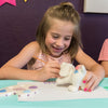 girl painting a ceramic dog at birthday party in Wisconsin Dells