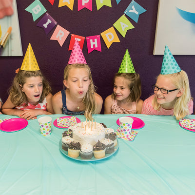 Girls blowing out birthday candles at paint your own pottery birthday party Wisconsin dells